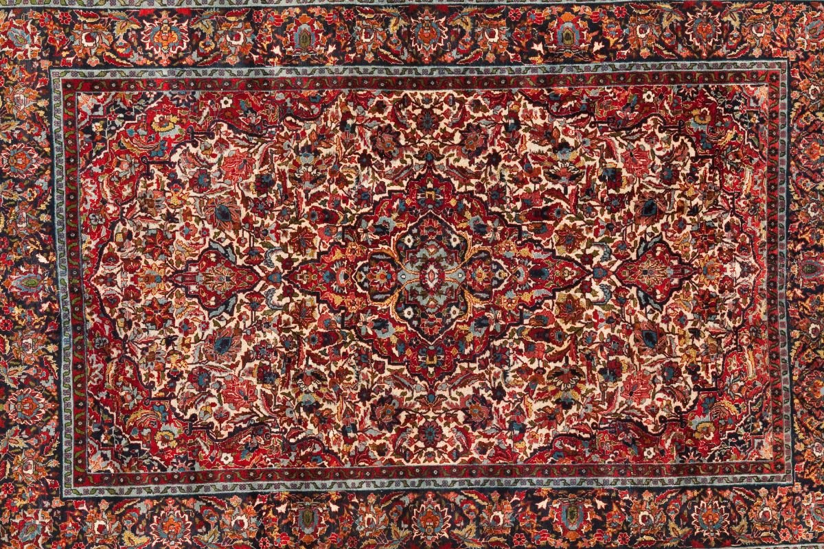 A Kerman Persian rug, approximately 10ft x 12ft, showcasing intricate patterns and rich colors, ideal for selecting carpet materials. 